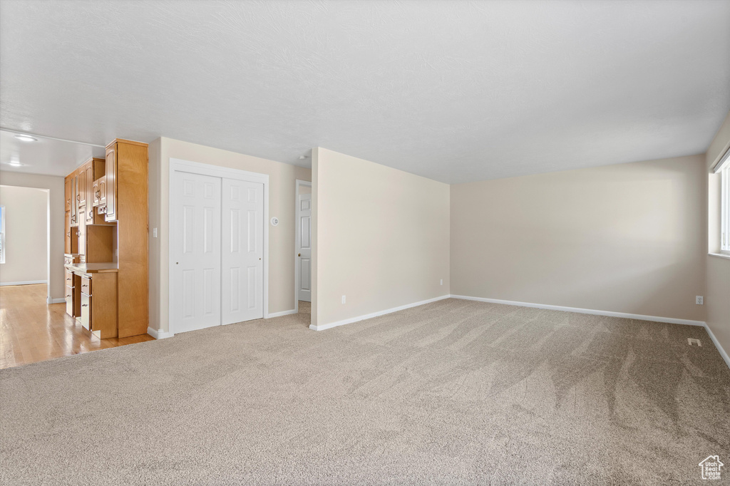 Interior space featuring light carpet and baseboards