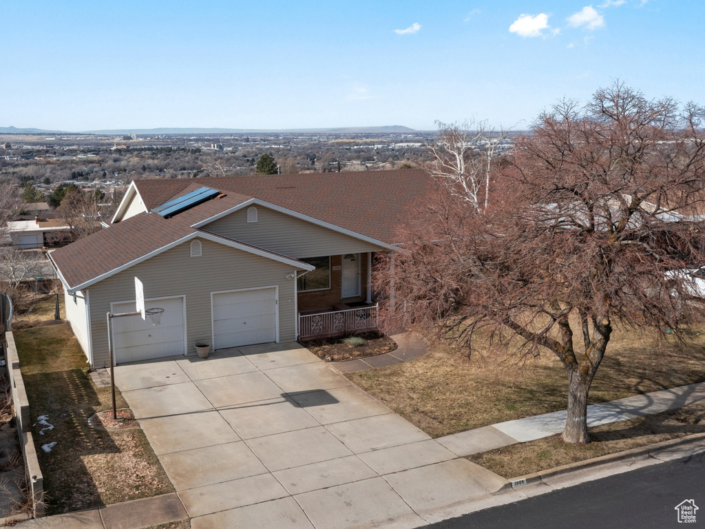 View of front of house with a garage, covered porch, and concrete driveway