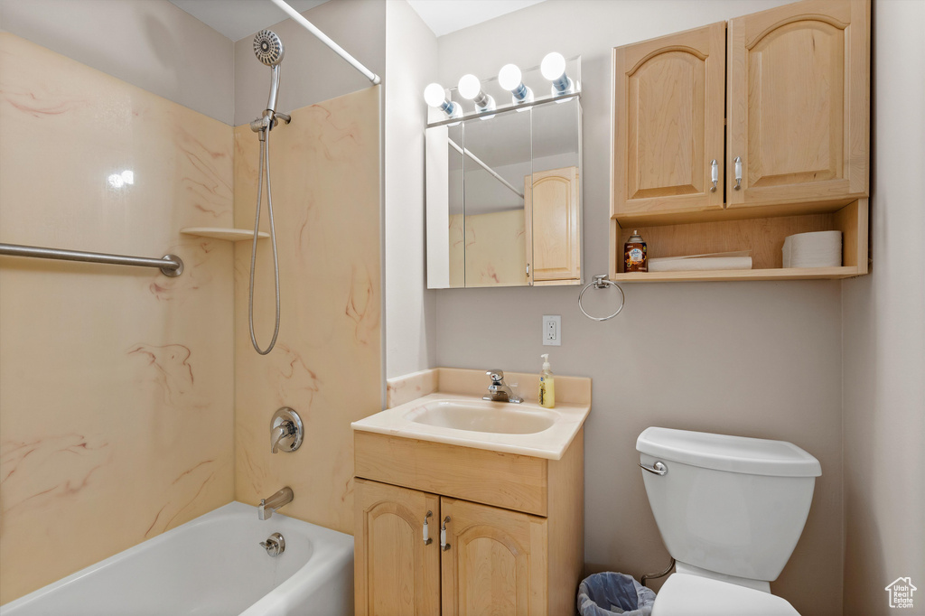 Bathroom featuring bathing tub / shower combination, vanity, and toilet