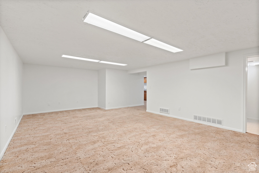 Unfurnished room with visible vents and baseboards