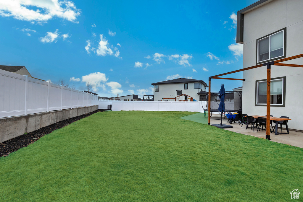 View of yard featuring a patio area and a fenced backyard