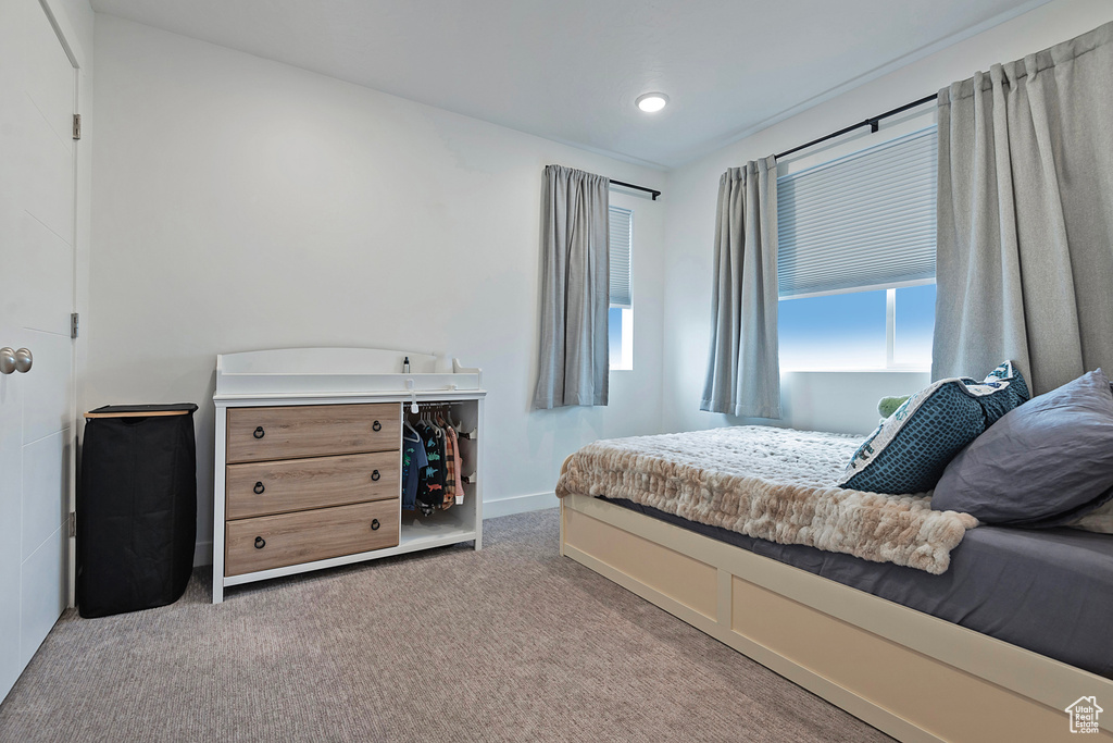 Bedroom featuring carpet floors and baseboards