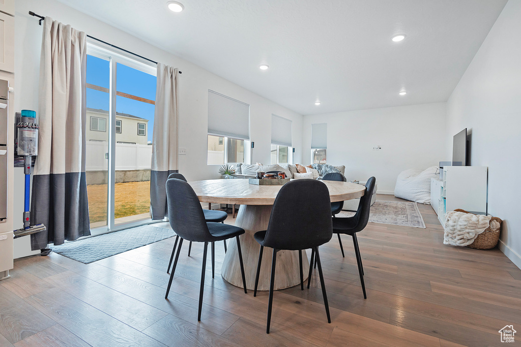 Dining space featuring baseboards, wood finished floors, and recessed lighting