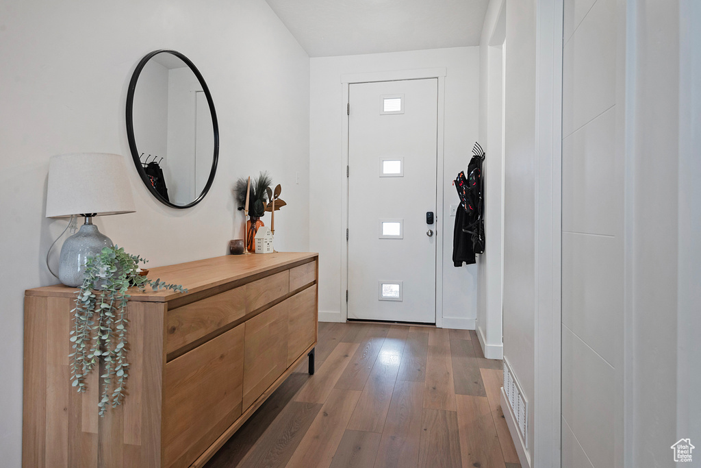 Entryway with light wood-type flooring and baseboards