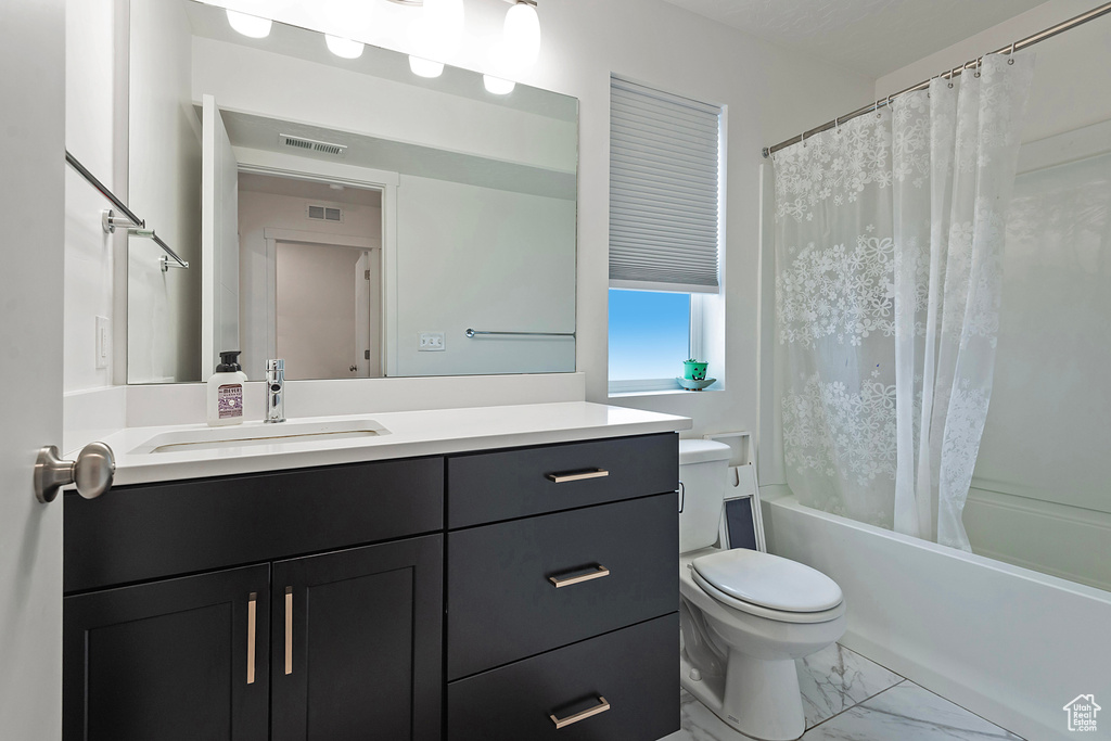 Bathroom featuring shower / bath combo, visible vents, toilet, marble finish floor, and vanity