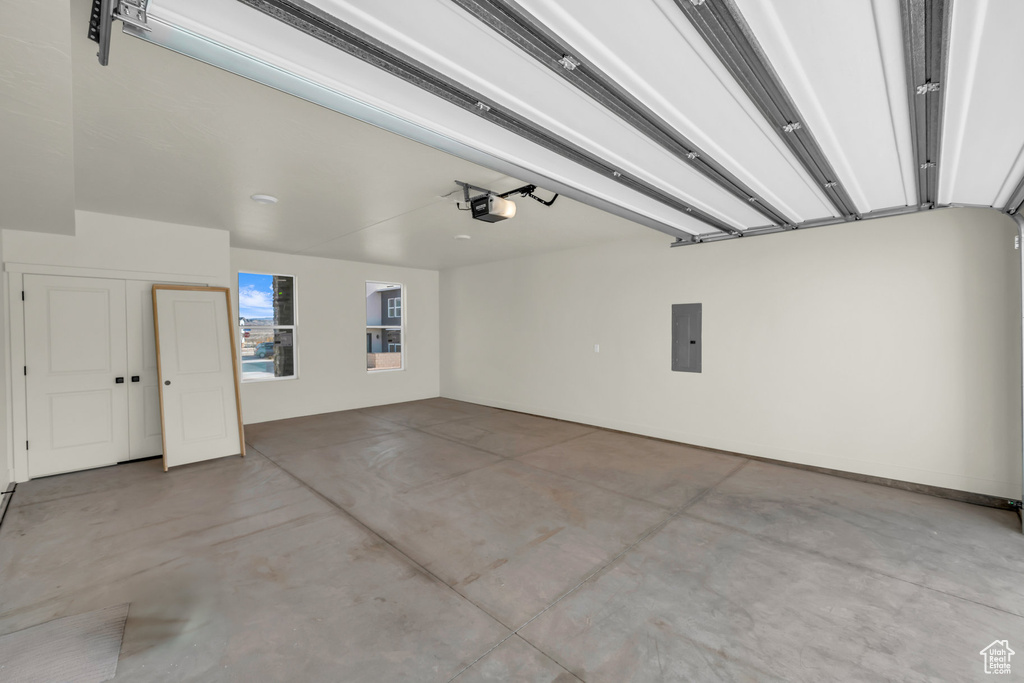 Garage with electric panel and a garage door opener