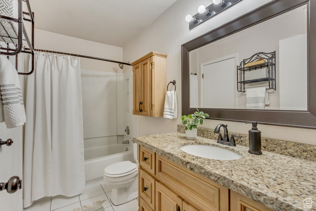 Bathroom with toilet, shower / bath combo, vanity, and tile patterned floors