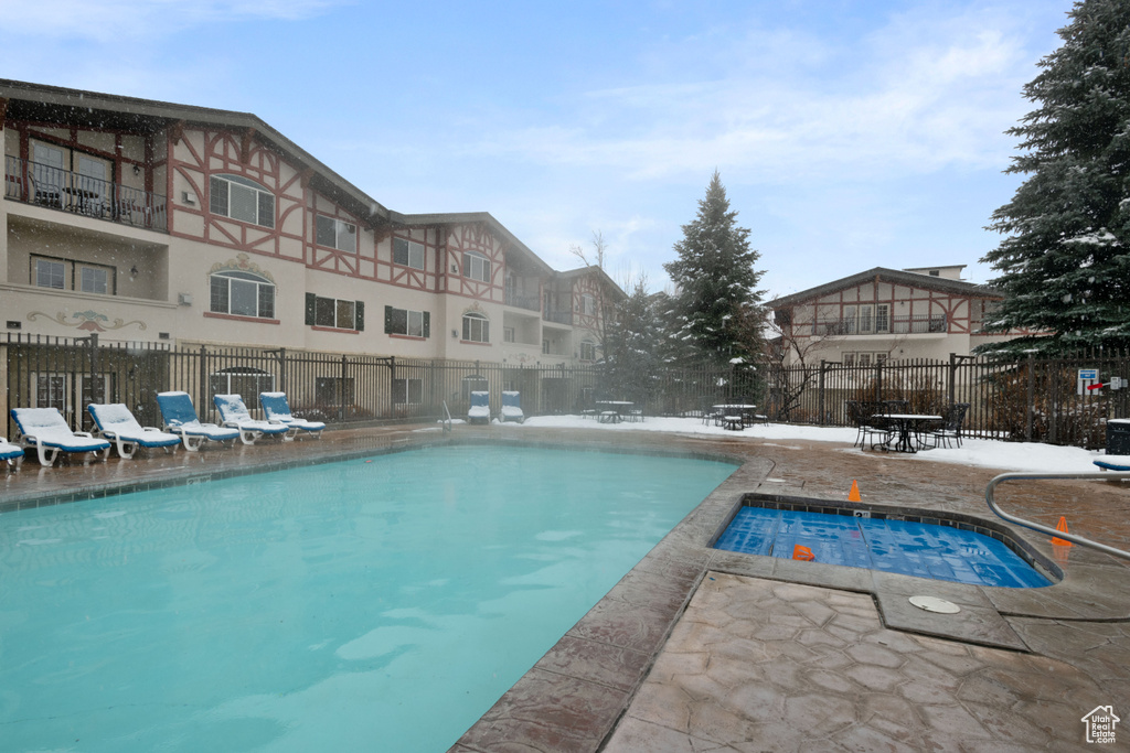 Community pool with fence and a patio