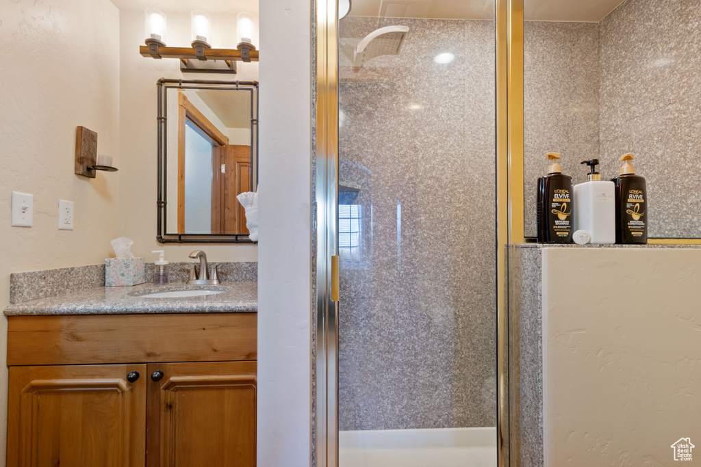 Bathroom featuring a stall shower and vanity