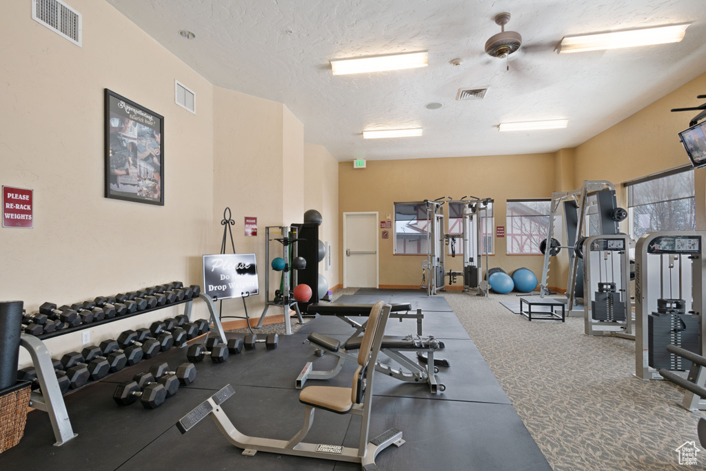 Gym featuring a textured ceiling and visible vents
