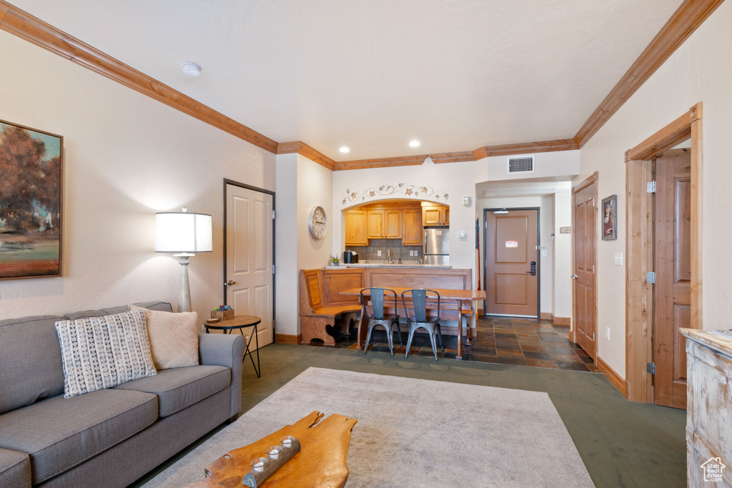 Living room featuring ornamental molding and baseboards