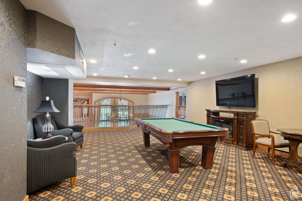 Rec room featuring a textured wall, pool table, a fireplace, and recessed lighting