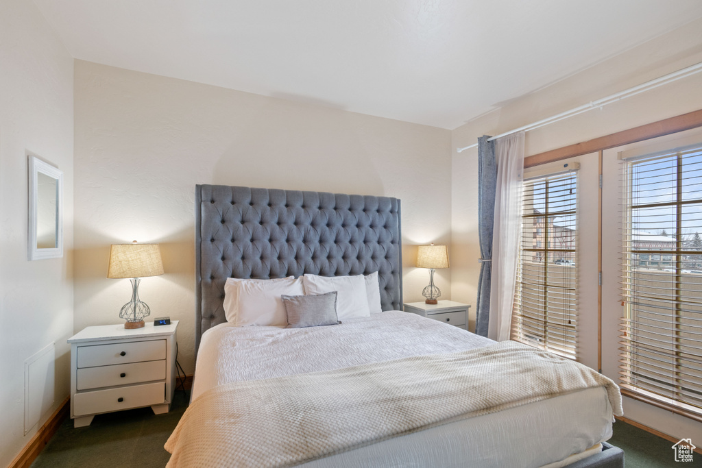 Carpeted bedroom featuring baseboards