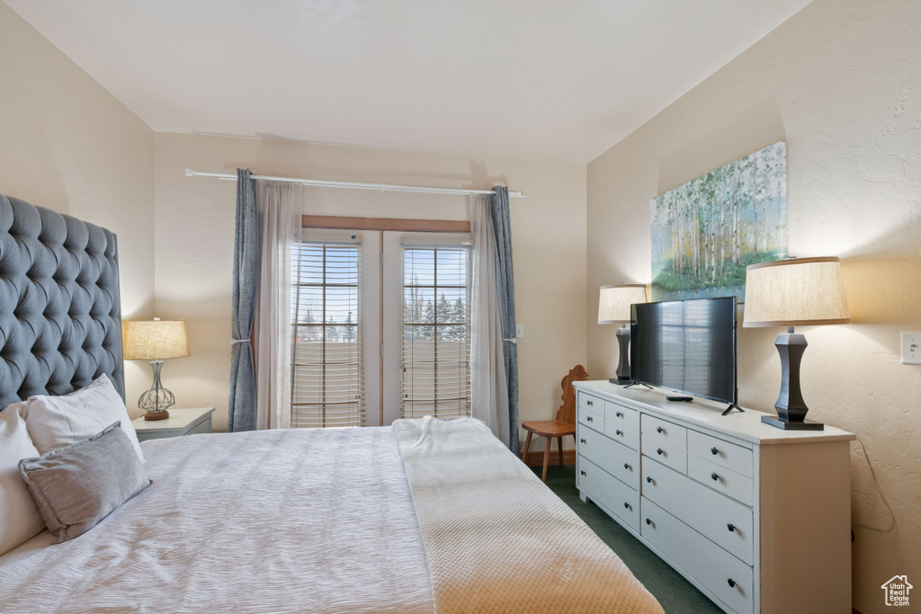 Bedroom featuring dark carpet