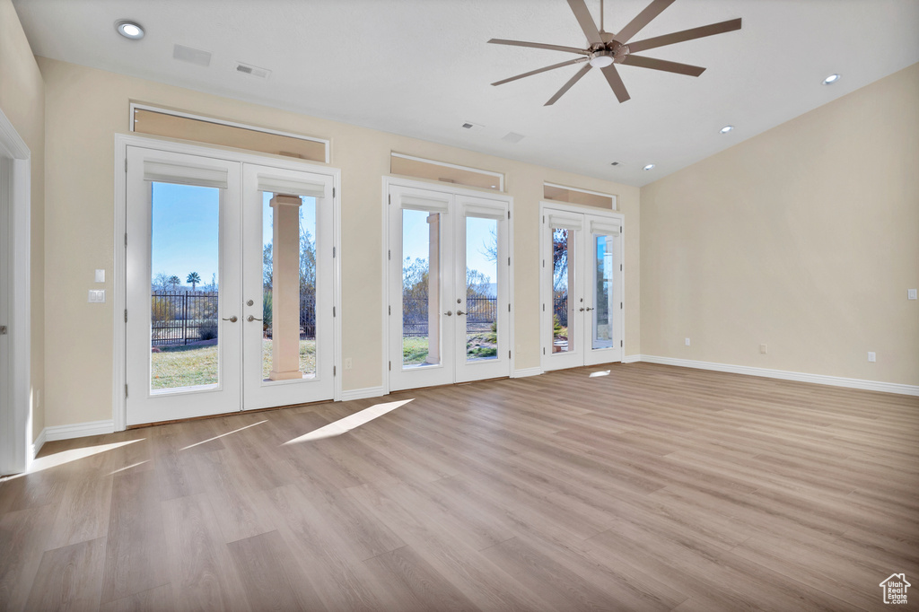Foyer entrance featuring french doors, light wood-style flooring, and baseboards
