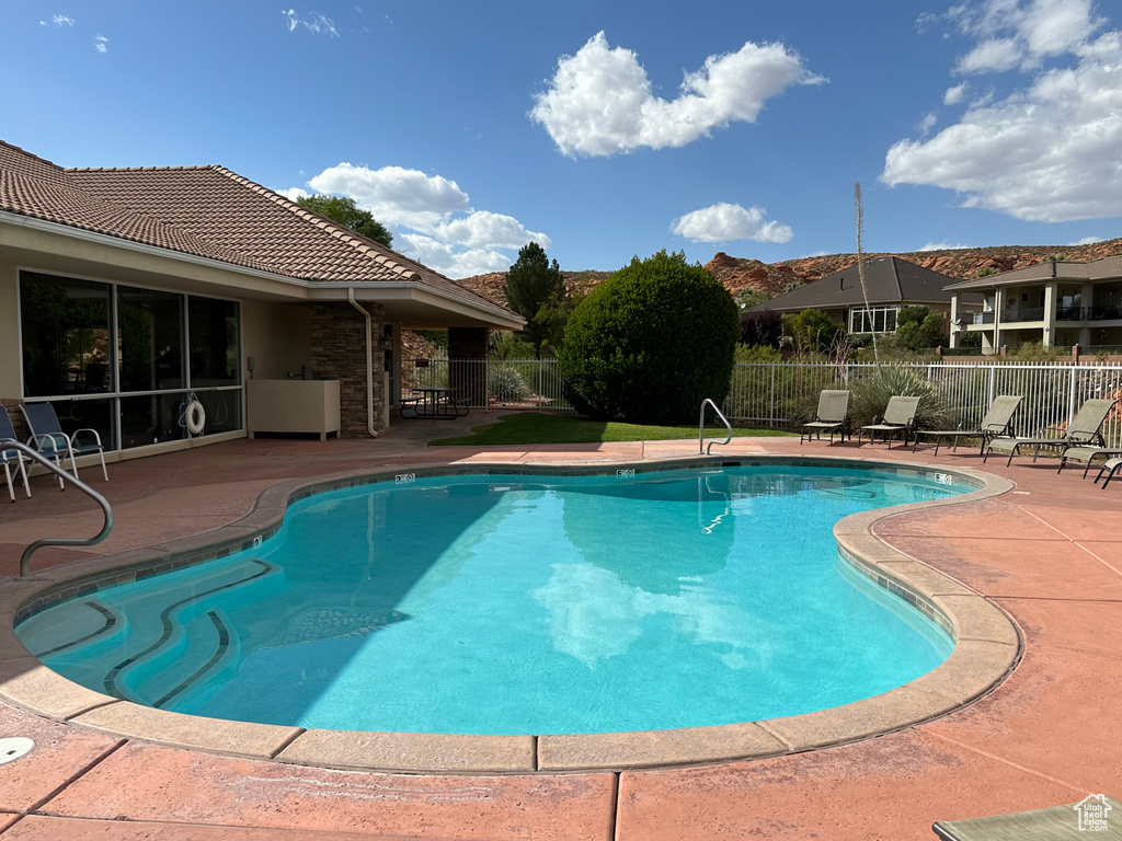 Pool featuring fence and a patio