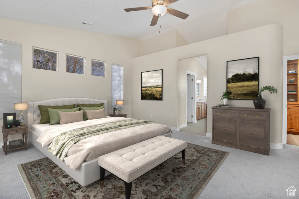 Bedroom featuring baseboards, light colored carpet, ceiling fan, and ensuite bath
