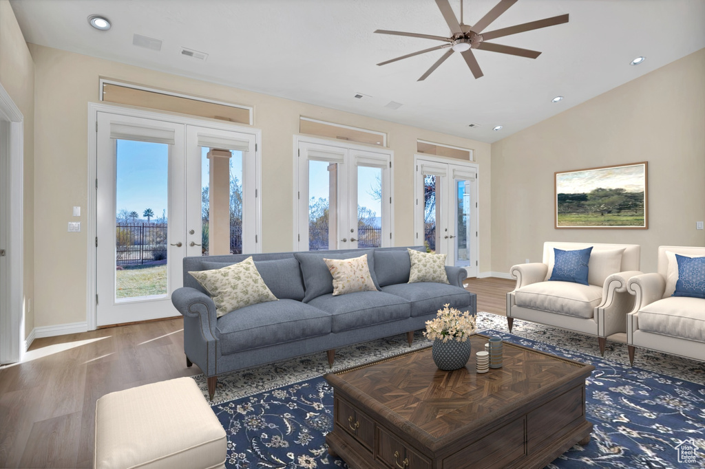 Living area with vaulted ceiling, french doors, wood finished floors, and visible vents