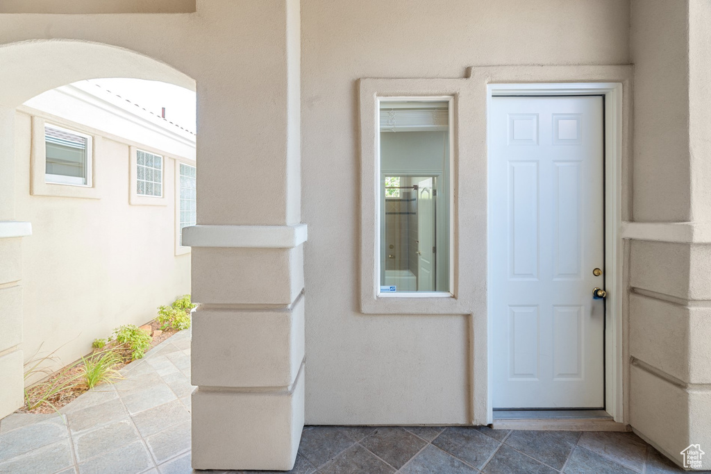 View of exterior entry with stucco siding