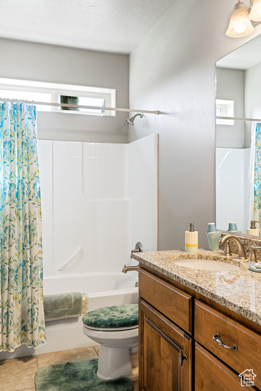 Bathroom featuring toilet, vanity, shower / bath combination with curtain, and tile patterned floors