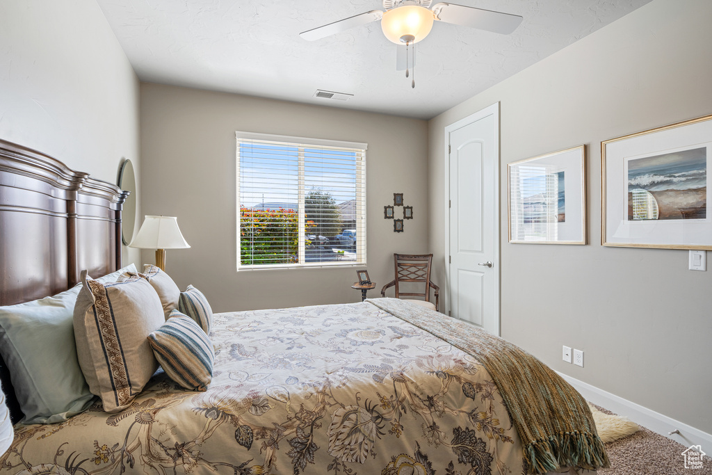 Bedroom with a ceiling fan, visible vents, and baseboards