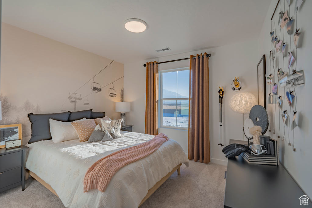 Bedroom with light carpet and visible vents
