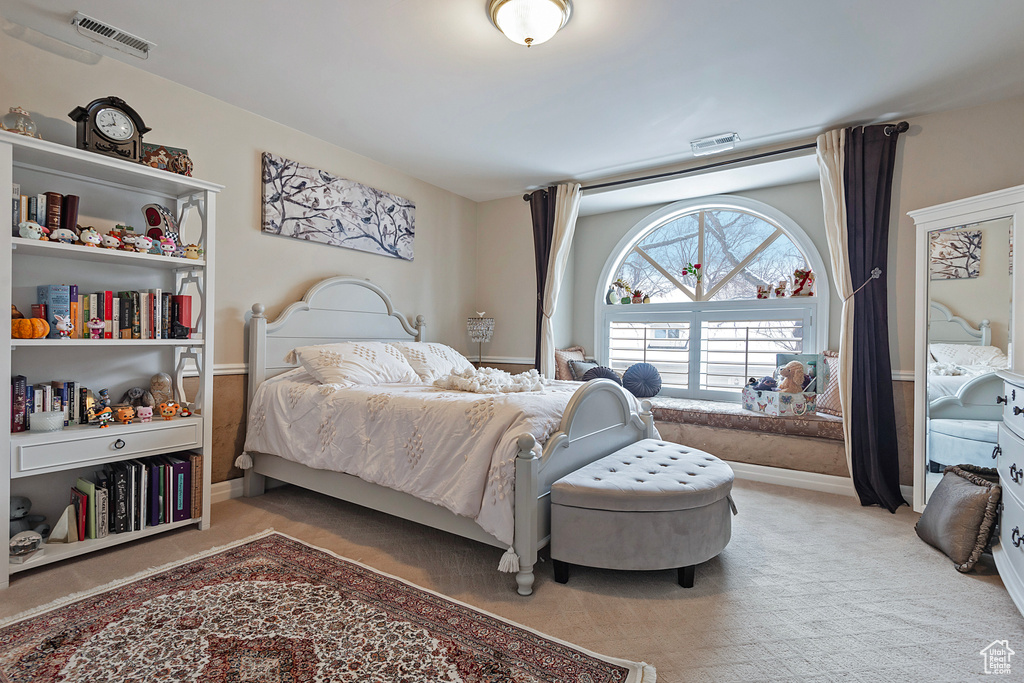 Bedroom with light carpet, baseboards, and visible vents