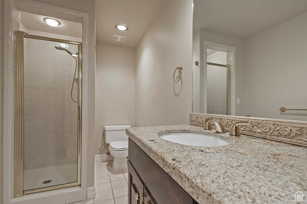 Bathroom featuring visible vents, a stall shower, tile patterned flooring, and toilet