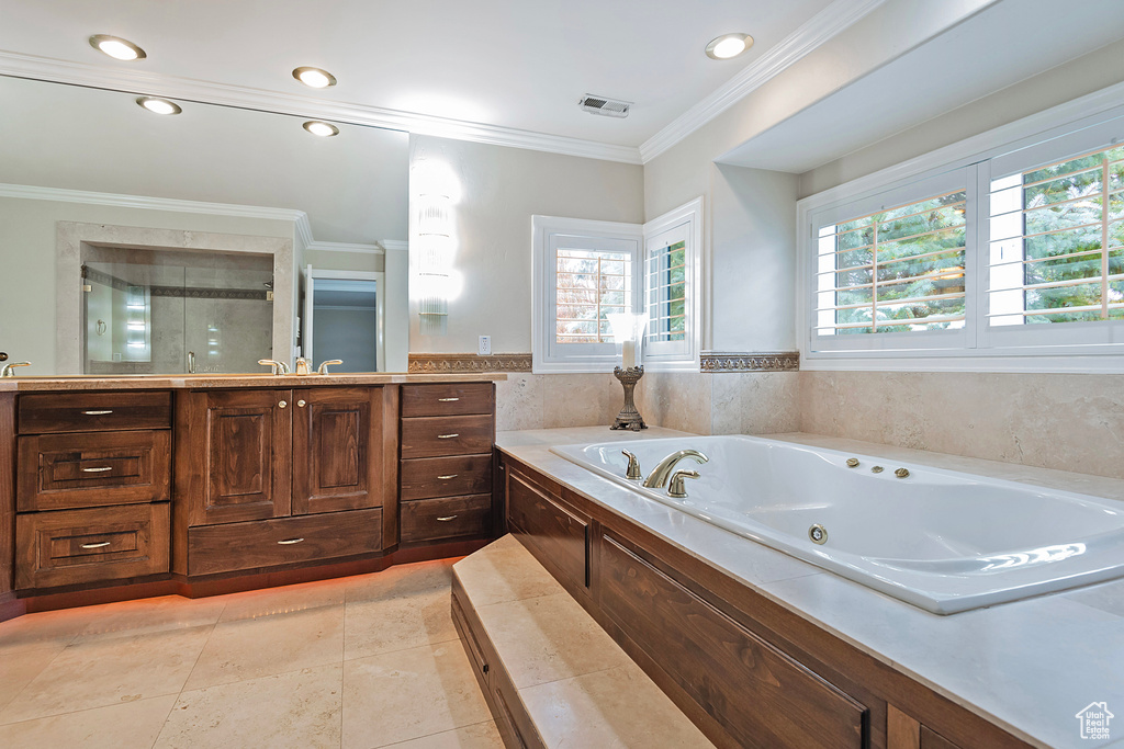 Full bath featuring recessed lighting, visible vents, ornamental molding, a shower stall, and a jetted tub