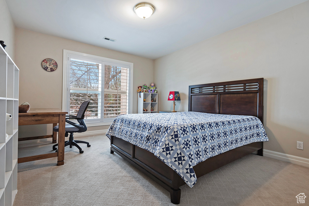 Bedroom with carpet, visible vents, and baseboards