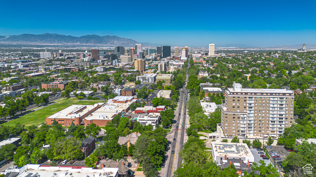 Aerial view of property's location with a mountainous background and nearby urban area