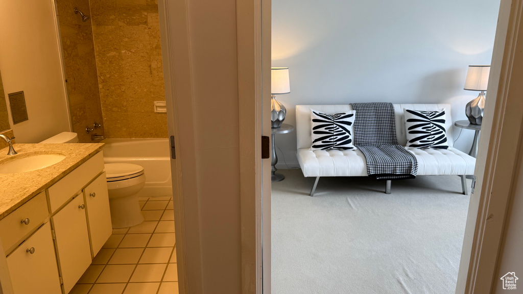 Bathroom with toilet, tile patterned flooring, vanity, and tub / shower combination