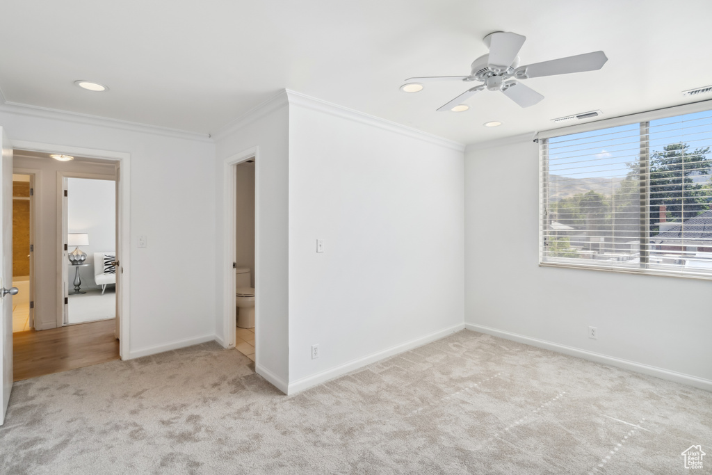 Spare room with carpet floors, ornamental molding, ceiling fan, and recessed lighting