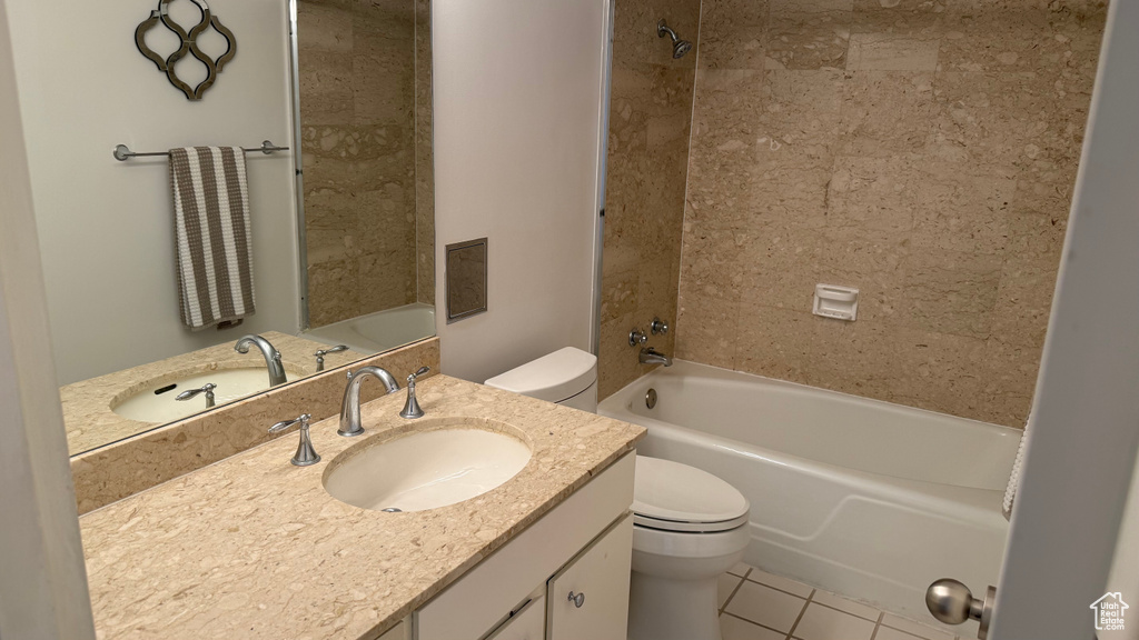 Bathroom featuring toilet, shower / bathtub combination, tile patterned floors, and vanity