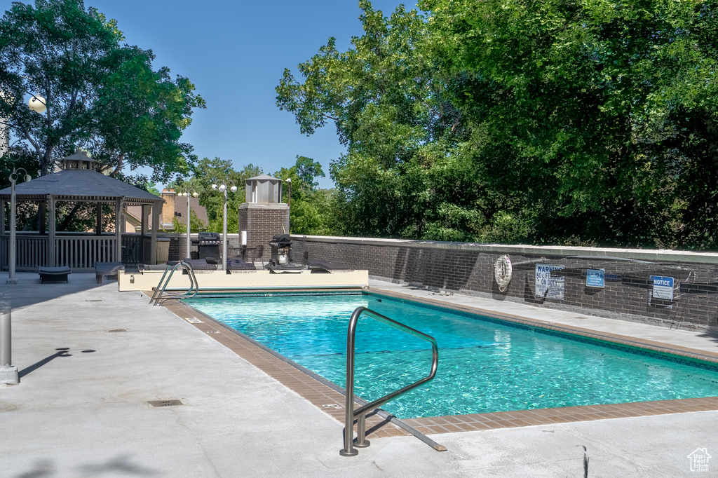 Community pool with a gazebo and a patio area