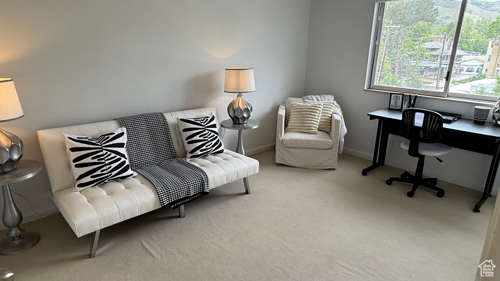 Carpeted home office featuring baseboards
