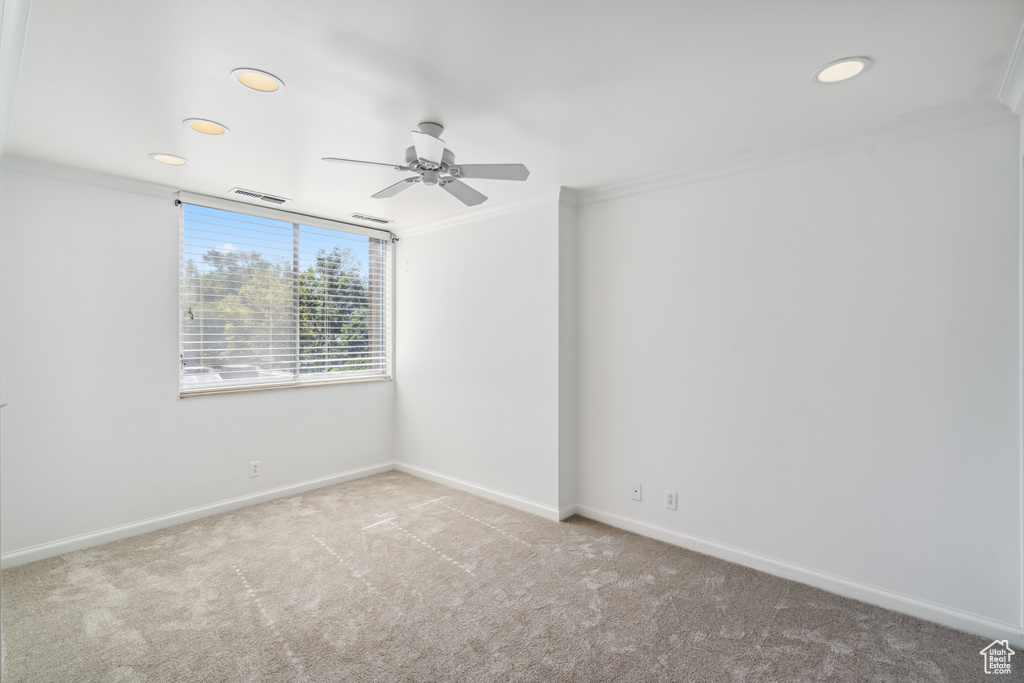 Carpeted spare room with ornamental molding, a ceiling fan, and recessed lighting