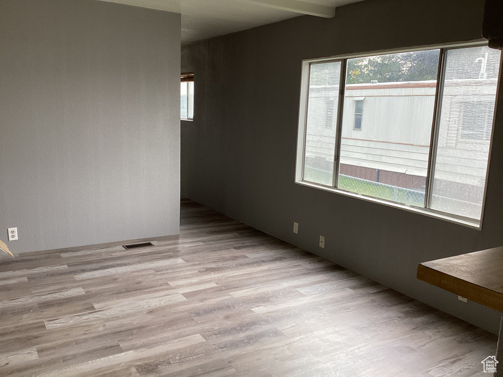 Spare room featuring visible vents and wood finished floors