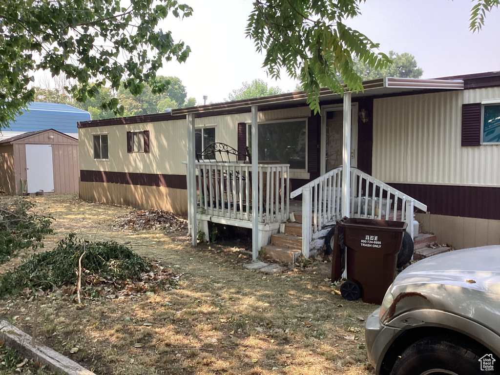 Manufactured / mobile home featuring a storage unit and an outdoor structure