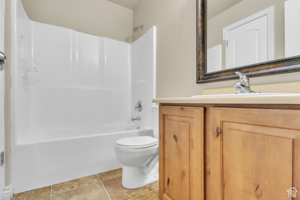Bathroom featuring toilet, washtub / shower combination, vanity, and tile patterned floors