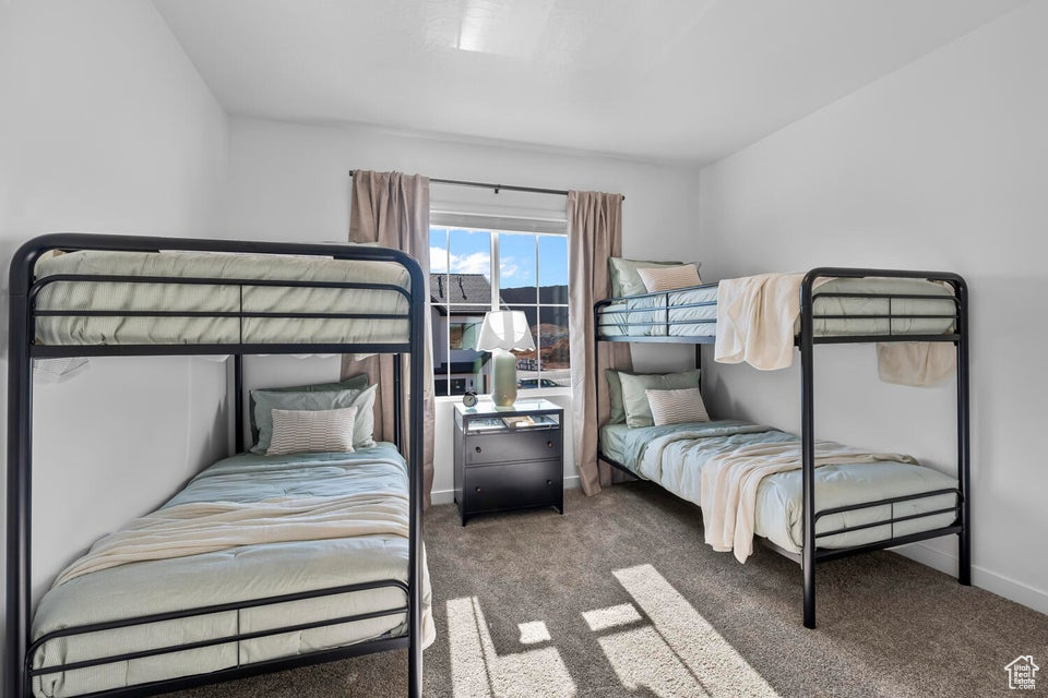Bedroom with carpet floors and baseboards