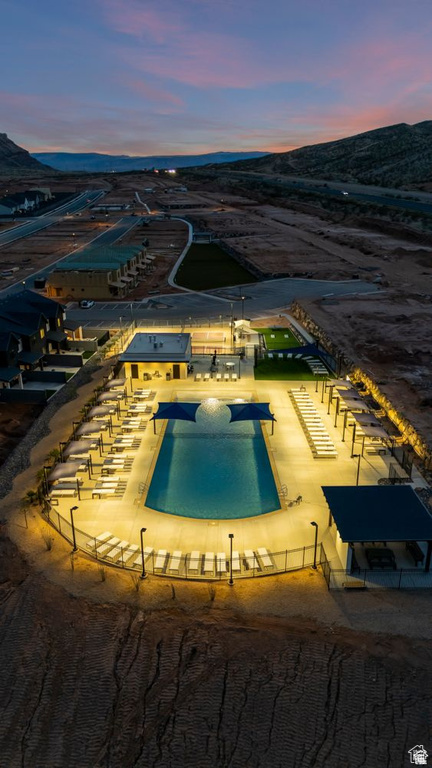 Pool at dusk featuring a mountain view