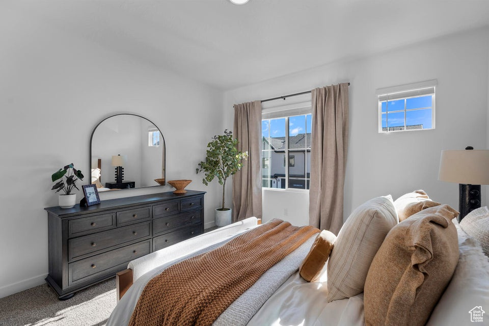 Bedroom featuring carpet floors and baseboards