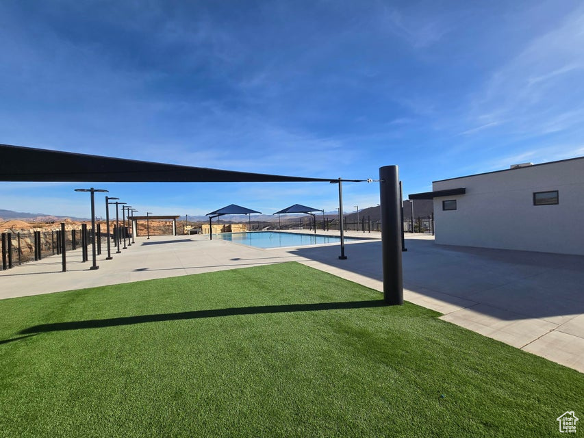 Exterior space featuring fence and a community pool