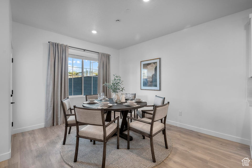 Dining area featuring light wood-type flooring, baseboards, and recessed lighting