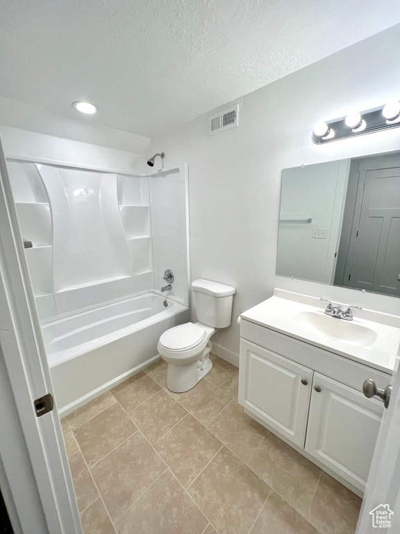 Bathroom with visible vents, toilet, a textured ceiling, vanity, and shower / bathing tub combination