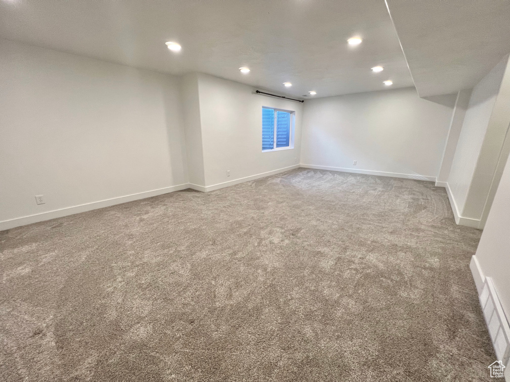 Finished below grade area with carpet floors, visible vents, baseboards, and recessed lighting