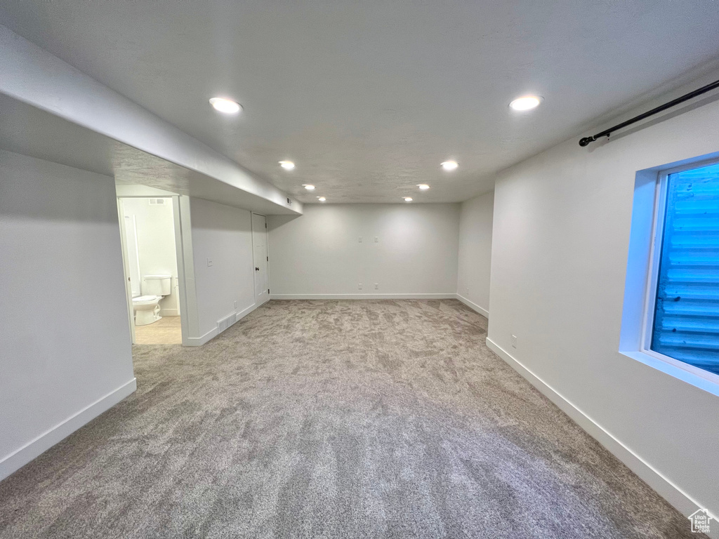 Finished basement with recessed lighting, baseboards, and light colored carpet