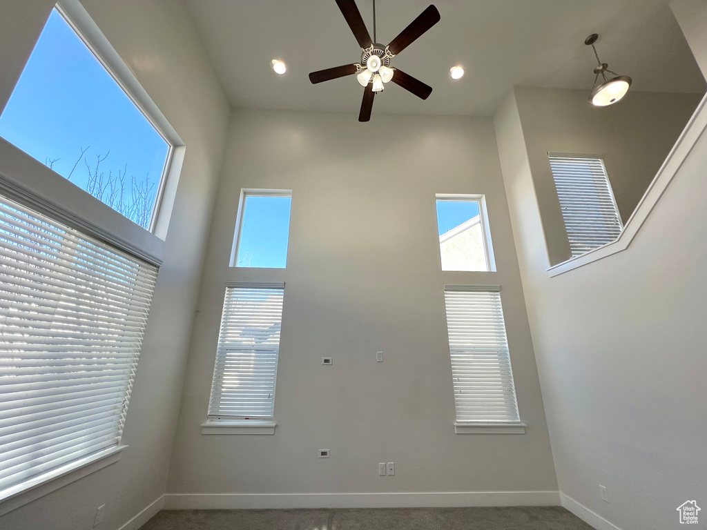 Interior space with recessed lighting, a towering ceiling, and baseboards
