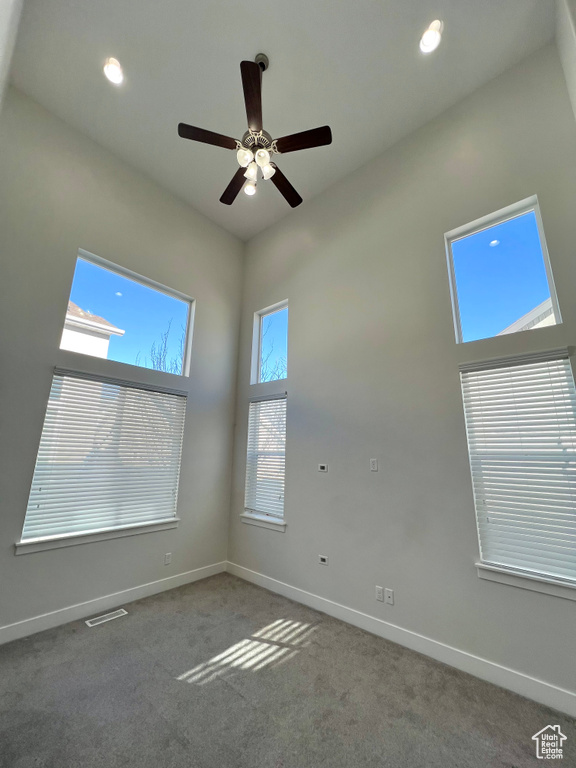 Unfurnished room featuring visible vents, baseboards, ceiling fan, carpet, and recessed lighting